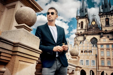 A tourist in Old Town Square holding Czech unique jeweller's flowers