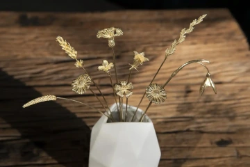 Bouquet of golden flowers in a white vase Rosenthal