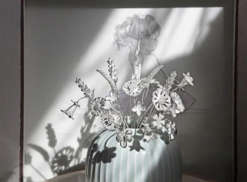 A bouquet of silver flowers in a family vase of jewelry