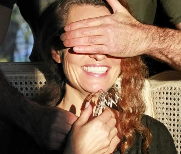 Silver snowdrops in hands of a smiling woman
