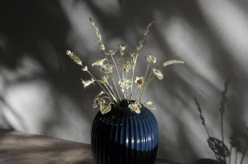 Velká kytice zlatých květin v modré váze pro obchodního partnery