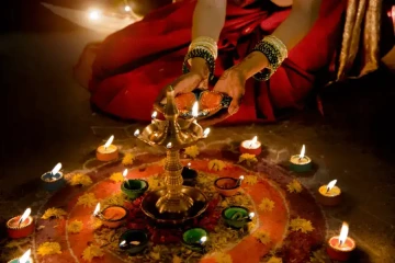 Sitting woman with candles during Diwali festival