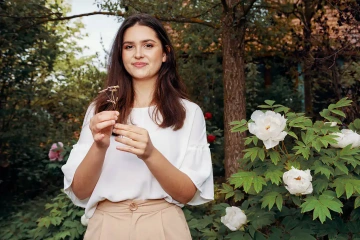 Girlfriend in the garden with a romantic silver forget-me-not given as a gift