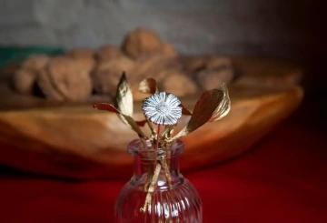 Silver daisy with mistletoe in a glass vase for a corporate Christmas gift