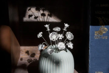Bouquet of GIYOU silver flowers in a vase with books; a graduation gift