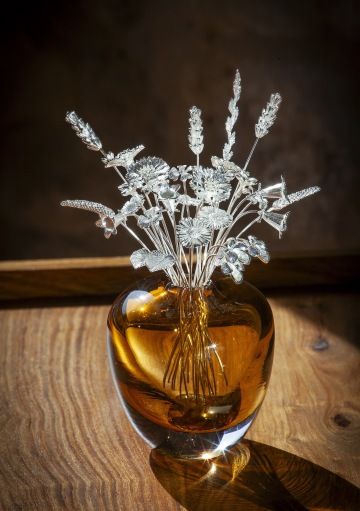 A bouquet of GIYOU silver flowers in a brown glass vase