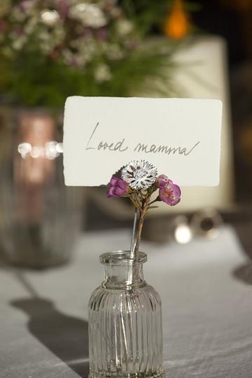 Wedding place cards with one silver flower at the wedding