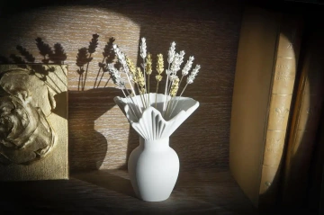 Floral jewelry of silver lavenders in a vase in a bookcase, silver decoration