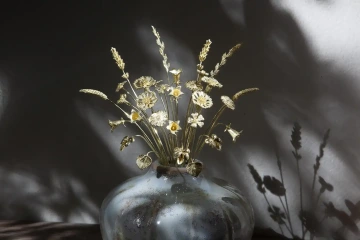 Large Royal bouquet of flowers of gold in a vase