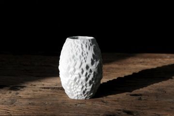 White Rosenthal porcelain vase on a wooden table.