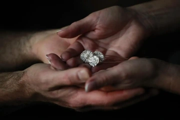 Donated silver flowers in the hands of employees