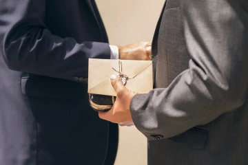 Gift for a business partner in hands of two men