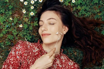 A lying woman holding a romantic gift of a silver flowers