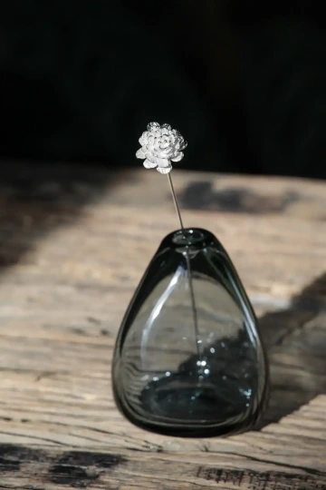 Květina ze stříbra ve váze ze skla k Vánocům