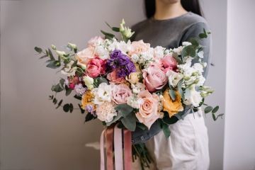 A big bouquet of flowers in the hands of a woman