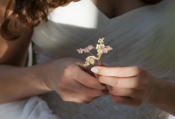 Bride holding golden wedding flowers, alternative wedding rings - unique wedding
