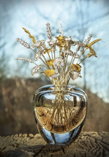 A bouquet of silver and gold flowers in a vase. A gift for the bride.