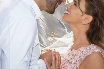 Ženich s nevěstou držící v ruce snubní květiny, netradiční snubní prsteny