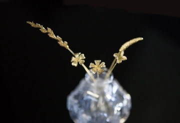 Bouquet of five golden flowers in a vase. Valentine gift