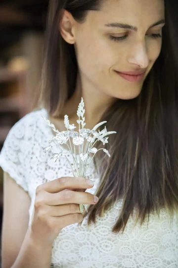 Woman with a gift bouquet of flowers made of silver for Christmas