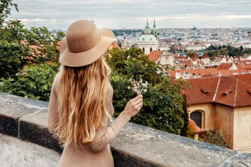 Woman in Prague Hradcany holding Czech jewellery flowers, unique gift from Prague
