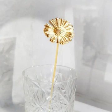 Golden daisy in a glass vase for mom