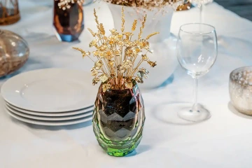A bouquet of golden flowers in a vase on festive table a piano for decoration of festive dining and tables